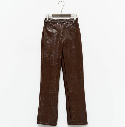 tight-fitting brown faux leather trousers