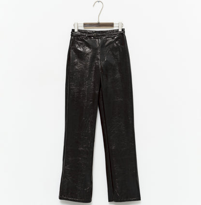 tight-fitting black faux leather trousers